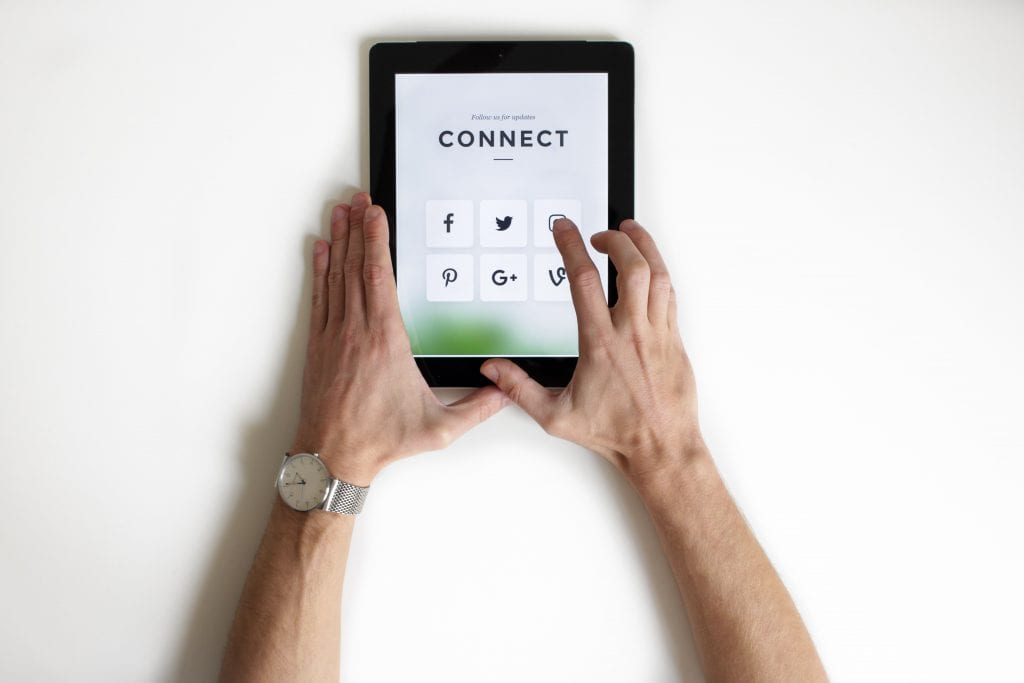 Male hands holding a tablet with social media platform logos and the word connect. 

Social media enables intense connection with consumers which is key for marketing your business - after all. consumers and clients are the foundations of all businesses. 