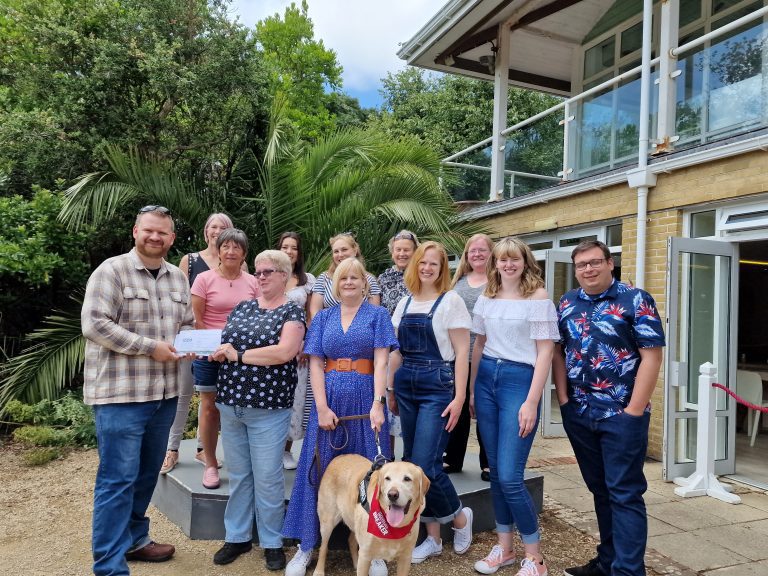 Kai Davis, owner of Lentil Marketing with a group of nurses and staff from St Mary's Hospital presenting NHS recovery passes for Ventnor Botanic Garden.
